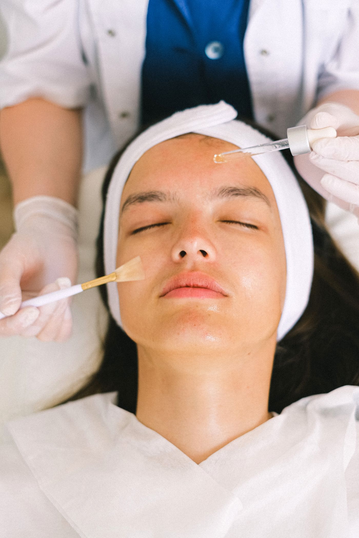 Aesthetic professional preparing a facial treatment