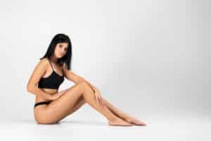 A woman posing in a black bra and underwear showing the results of Sentient Sculpt in Allen, TX